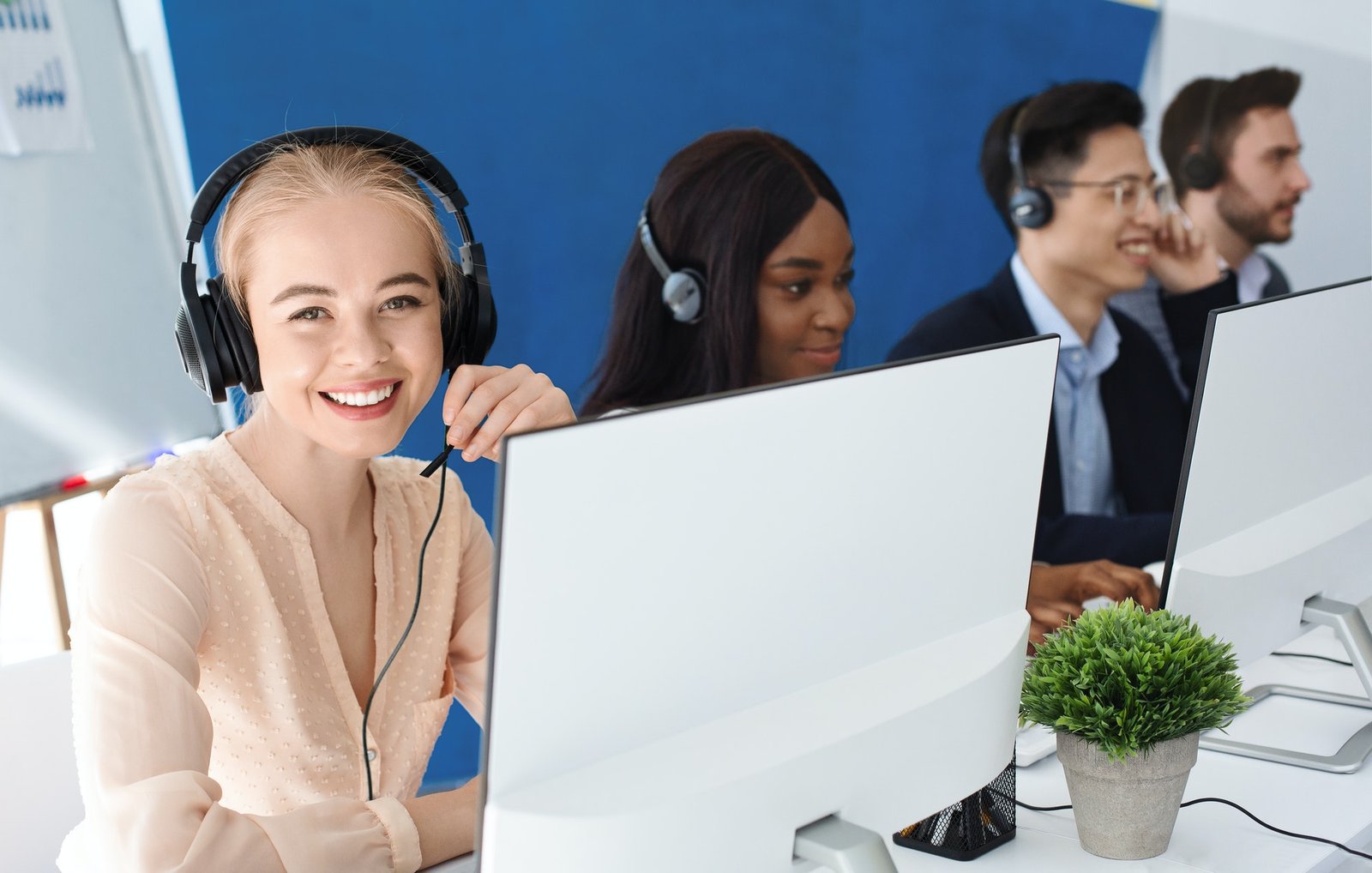 joyful-customer-service-agents-with-headphones-communicating-with-clients-at-call-center.jpg